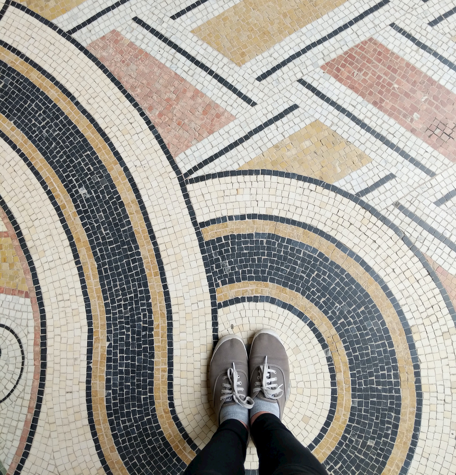 mosaic floor with shoes of photographer